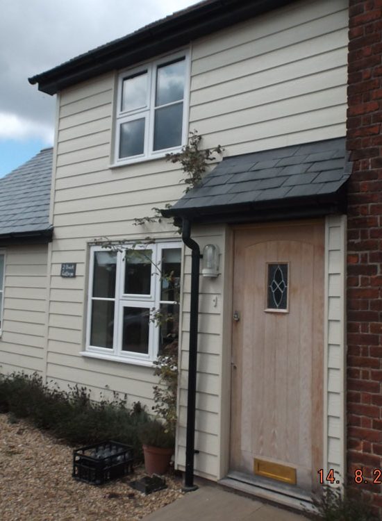 Two storey and single storey extension finished in weatherboarding