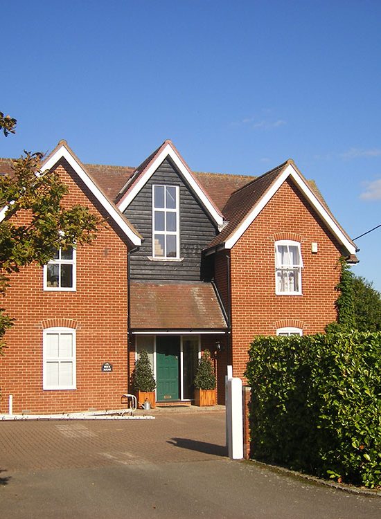 Front of the property with the new gable extension finished in black weatherboarding