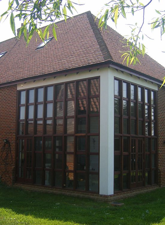 Two storey high timber windows to living room